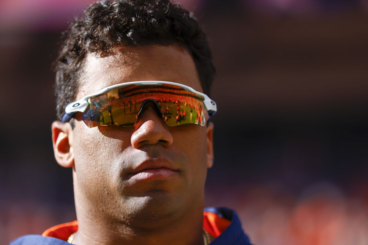 Russell Wilson #3 of the Denver Broncos watches his team warm up before their game against the New York Jets at Empower Field At Mile High on October 23, 2022 in Denver, Colorado.