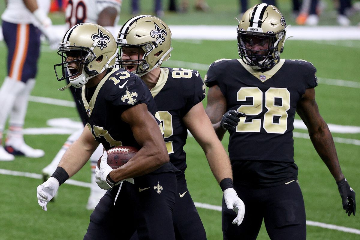 Michael Thomas, Adam Trautman, and Latavius Murray of the New Orleans Saints celebrate following Thomas’ 11-yard touchdown during the first quarter against the Chicago Bears in the NFC Wild Card Playoff game at Mercedes Benz Superdome on January 10, 2021 in New Orleans, Louisiana.