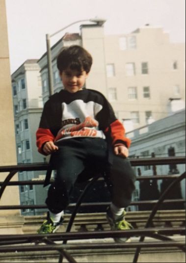 A young Darren Criss in San Francisco with a Giants sweater.