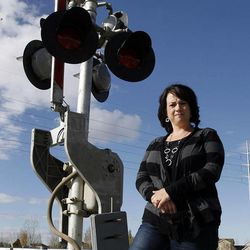 Jill Welch of Farmington poses for a photo Tuesday, Nov. 15, 2011 at 600 Old Mill Lane in Kaysville. She had a close call with a train while crossing the tracks here in her automobile.