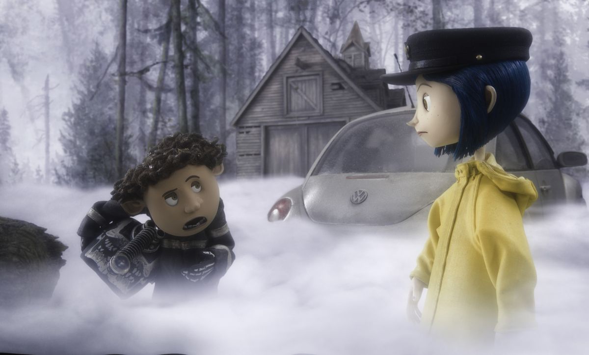 Wybie and Coraline stand in the mist outside her house.