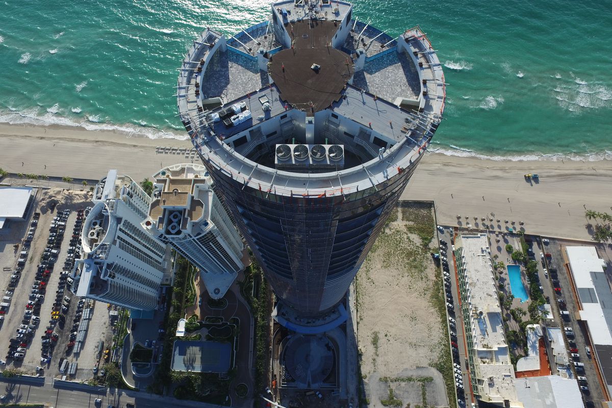 Aerial of a circular tower on the ocean in Sunny Isles