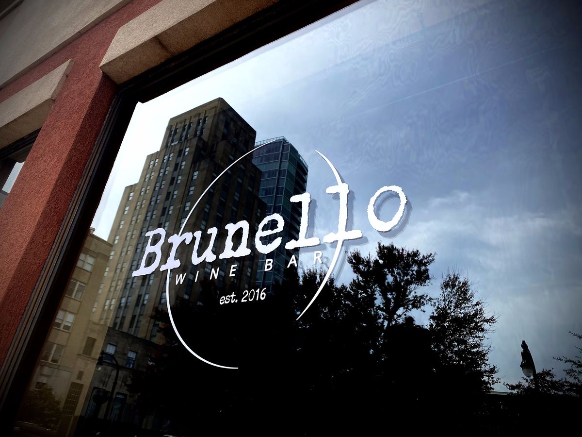 Window with a Brunello Wine Bar logo.