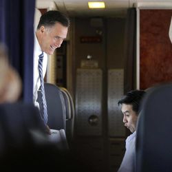 Republican presidential candidate and former Massachusetts Gov. Mitt Romney is seen with Policy Director Lanhee Chen on their campaign plane as it flies to Salt Lake City, Utah, Tuesday, Sept. 18, 2012.  