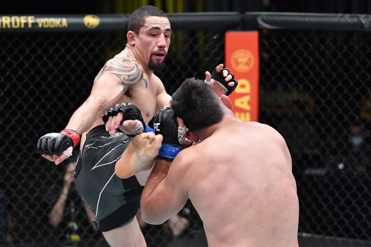 In this handout photo, (L-R) Robert Whittaker of Australia kicks Kelvin Gastelum in a middleweight fight during the UFC Fight Night event at UFC APEX on April 17, 2021 in Las Vegas, Nevada.