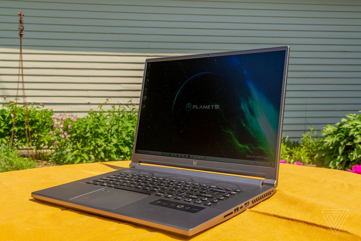 The Acer Predator Triton 500 SE on a yellow tablecloth in a garden, open, angled to the left. The screen displays the Planet9 logo on a celestial background.