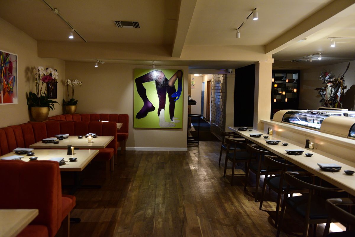 A restaurant with a sushi preparation area, dining tables, and art at Leona’s Sushi House in Studio City, California.