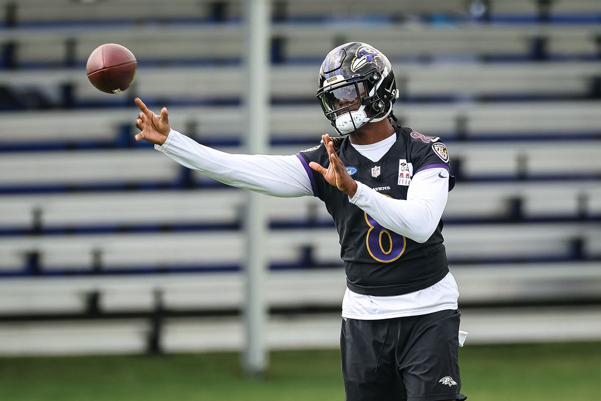 Lamar Jackson #8 of the Baltimore Ravens attempts a pass during training camp at Under Armour Performance Center Baltimore Ravens on July 27, 2023 in Owings Mills, Maryland.