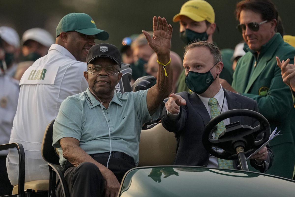 Lee Elder waves as he arrives for the ceremonial tee shots before the first round of the Masters golf tournament on Thursday, April 8, 2021, in Augusta, Ga. Elder broke down racial barriers as the first Black golfer to play in the Masters and paved the way for Tiger Woods and others to follow. 