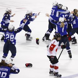 Canada's Meghan Agosta skates away as the United States players celebrate after winning the women's gold medal hockey game against Canada at the 2018 Winter Olympics in Gangneung, South Korea, Thursday, Feb. 22, 2018.