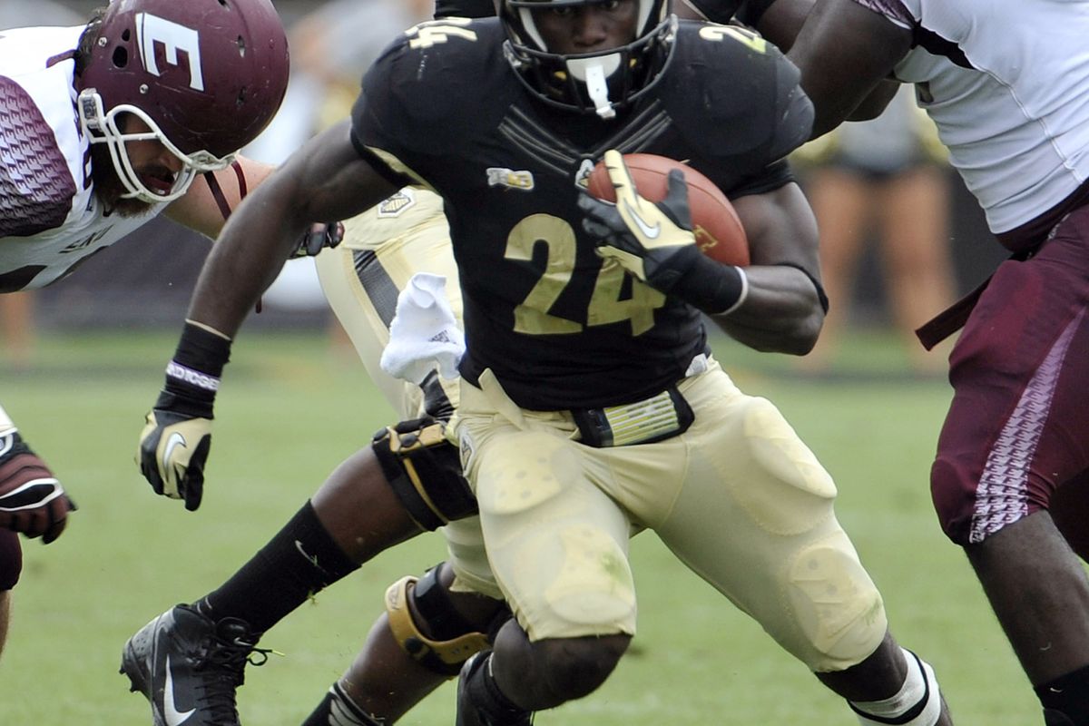 September 1, 2012; West Lafayette, IN, USA;  Purdue Boilermakers running back Akeem Shavers (24) runs up field past Eastern Kentucky Colonels defensive lineman Ryan Smith (98) at Ross Ade Stadium. Mandatory Credit: Sandra Dukes-US PRESSWIRE