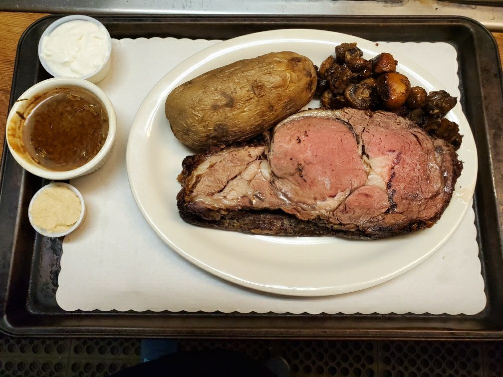 Prime rib, baked potato, and mushrooms, with au jus, sour cream, and horseradish on the side