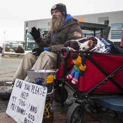 Fred Rivers, a homeless man originally from Bristol, Vermont, and now living in downtown Salt Lake City, waves to a passerby alongside his 7-year-old Chihuahua, Lucy Lou, near Vivint Smart Home Arena in Salt Lake City on Monday, Feb. 26, 2018. “When it gets about 3:30 or 4 o’clock in the morning it gets bone-chilling cold,” Rivers said. At that point in the night, he gets up and starts roaming around. “I learned over the years that if you’re cold and you just stay laying still, then you’re probably not going to wake up.”