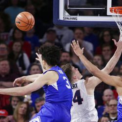 BYU guard Elijah Bryant (3) blocks a shot by Gonzaga forward Corey Kispert, middle, during the second half of an NCAA college basketball game in Spokane, Wash., Saturday, Feb. 3, 2018. BYU's Yoeli Childs is at right. Gonzaga won 68-60. (AP Photo/Young Kwak)