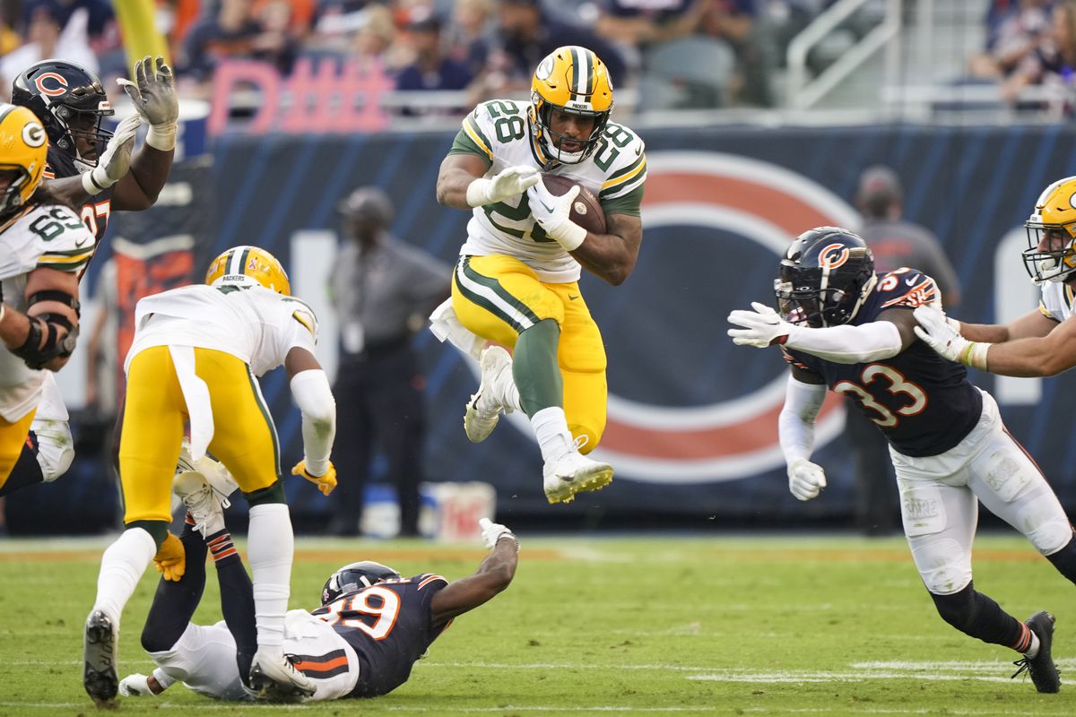 Running Back AJ Dillon of the Green Bay Packers runs the ball during an NFL football game against the Chicago Bears at Soldier Field on September 10, 2023 in Chicago, Illinois.