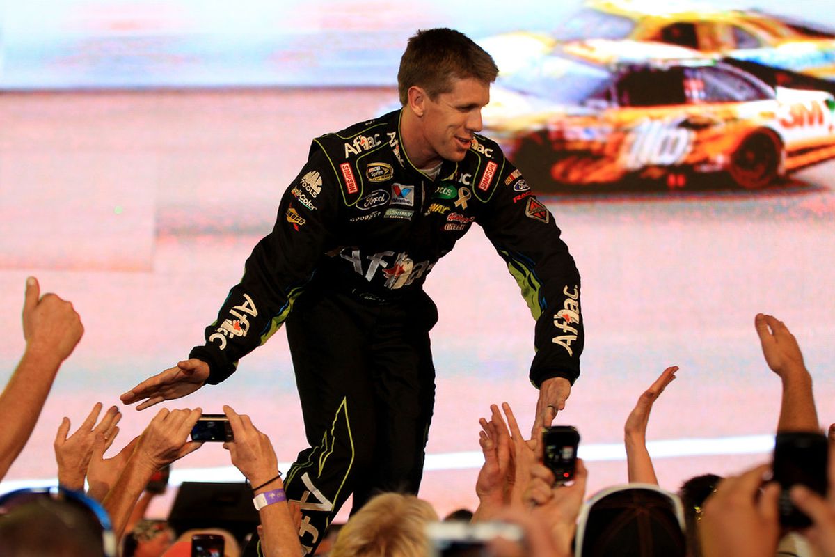 CHARLOTTE, NC - MAY 21:  Carl Edwards, driver of the #99 Aflac Ford, greets fans prior to the NASCAR Sprint All-Star Race at Charlotte Motor Speedway on May 21, 2011 in Charlotte, North Carolina.  (Photo by Streeter Lecka/Getty Images)