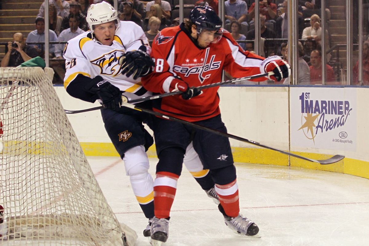 BALTIMORE, MD - SEPTEMBER 20: Kyle Wilson #28 of the Nashville Predators hits Brett Flemming #68 of the Washington Capitals at the 1st Mariner Arena on September 20, 2011 in Baltimore, Maryland.  (Photo by Bruce Bennett/Getty Images)
