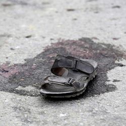 A victim's sandal is pictured near the Shiite Baqir-ul Ulom mosque after a suicide attack, in Kabul, Afghanistan, Monday, Nov. 21, 2016. An Afghan official says that dozens of civilians have been killed after a suicide bomber attacked a Shiite mosque in the capital. 
