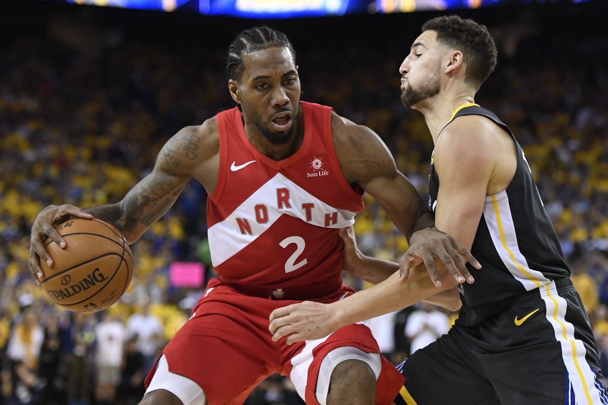 Toronto Raptors forward Kawhi Leonard (2) handles the ball while Golden State Warriors guard Klay Thompson defends during the second half of Game 6 of basketball’s NBA Finals, Thursday, June 13, 2019, in Oakland, Calif.