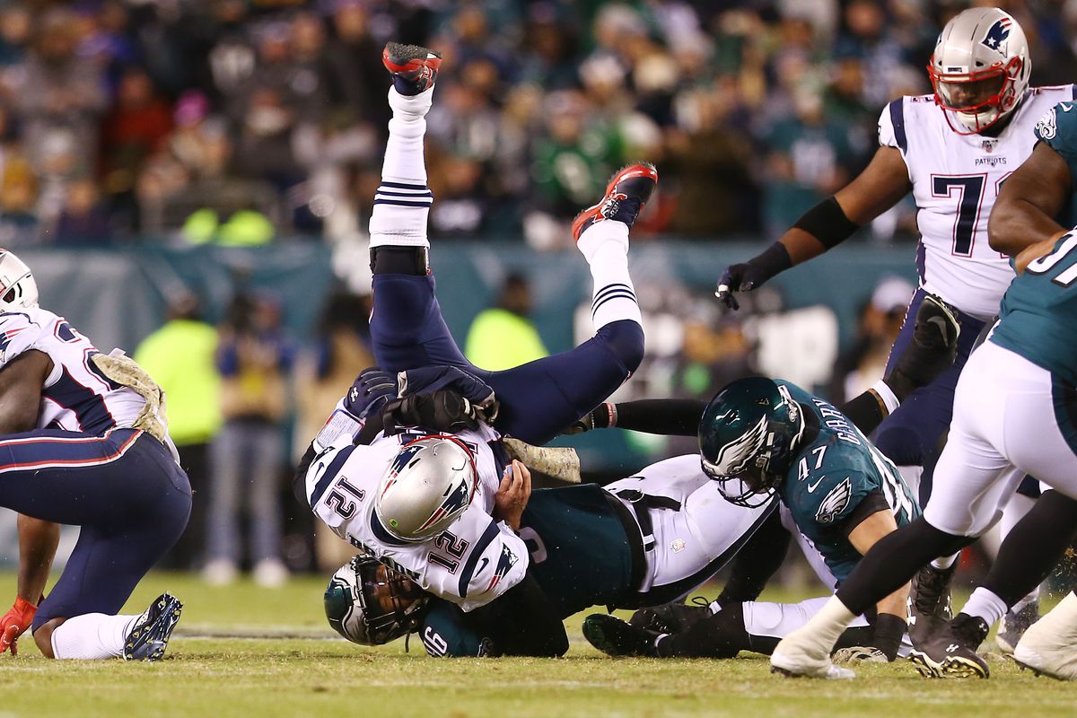 Tom Brady of the New England Patriots is upended by Derek Barnett and Nathan Gerry of the Philadelphia Eagles during the first half at Lincoln Financial Field on November 17, 2019 in Philadelphia, Pennsylvania.