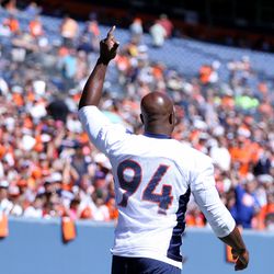 Broncos DE DeMarcus Ware waves to the fans as he makes his way to his workout. 