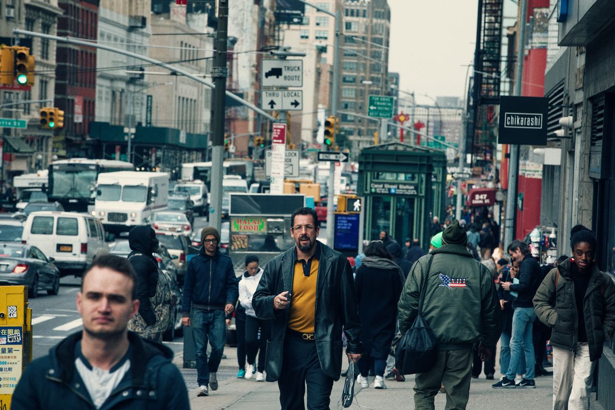 howard (adam sandler) walks down the street in new york city