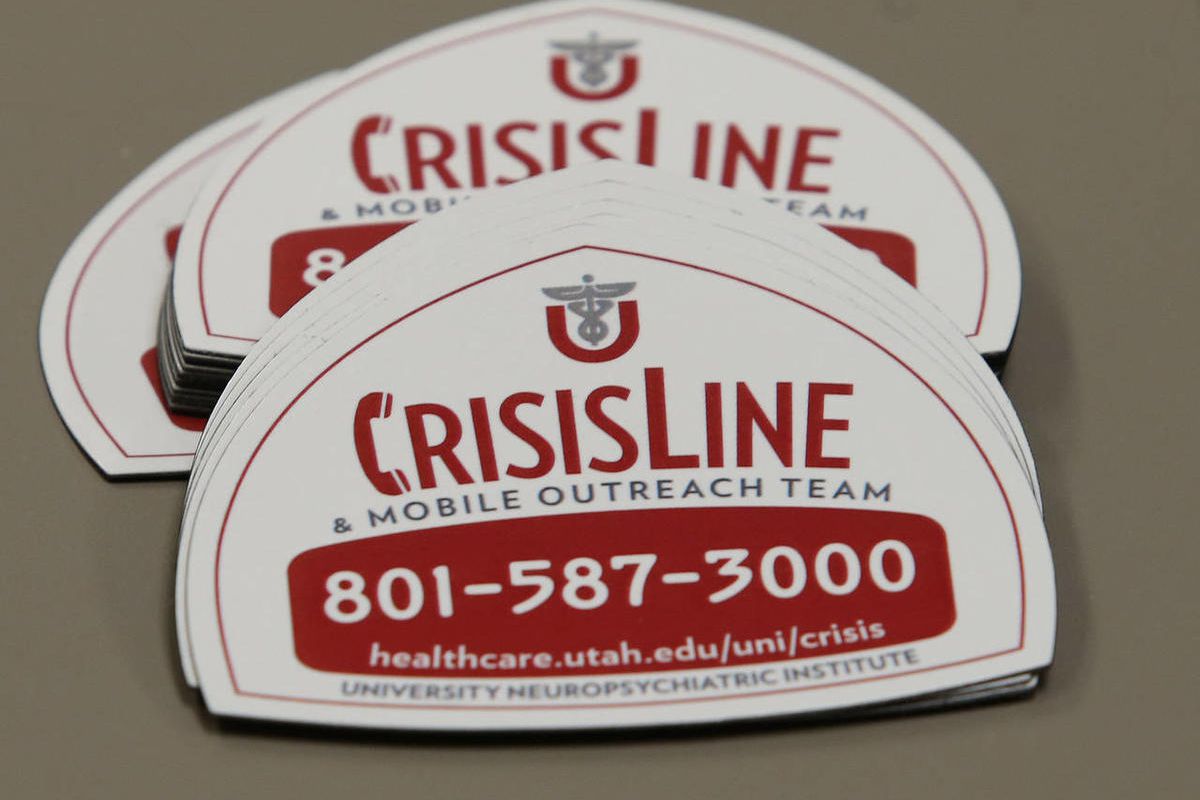 CrisisLine magnetic stickers, Thursday, Jan. 16, 2014, in Salt Lake City. Members of the media and mental health professionals met together Monday to discuss how they can work together to help bring hope, information and resources to those in crisis.