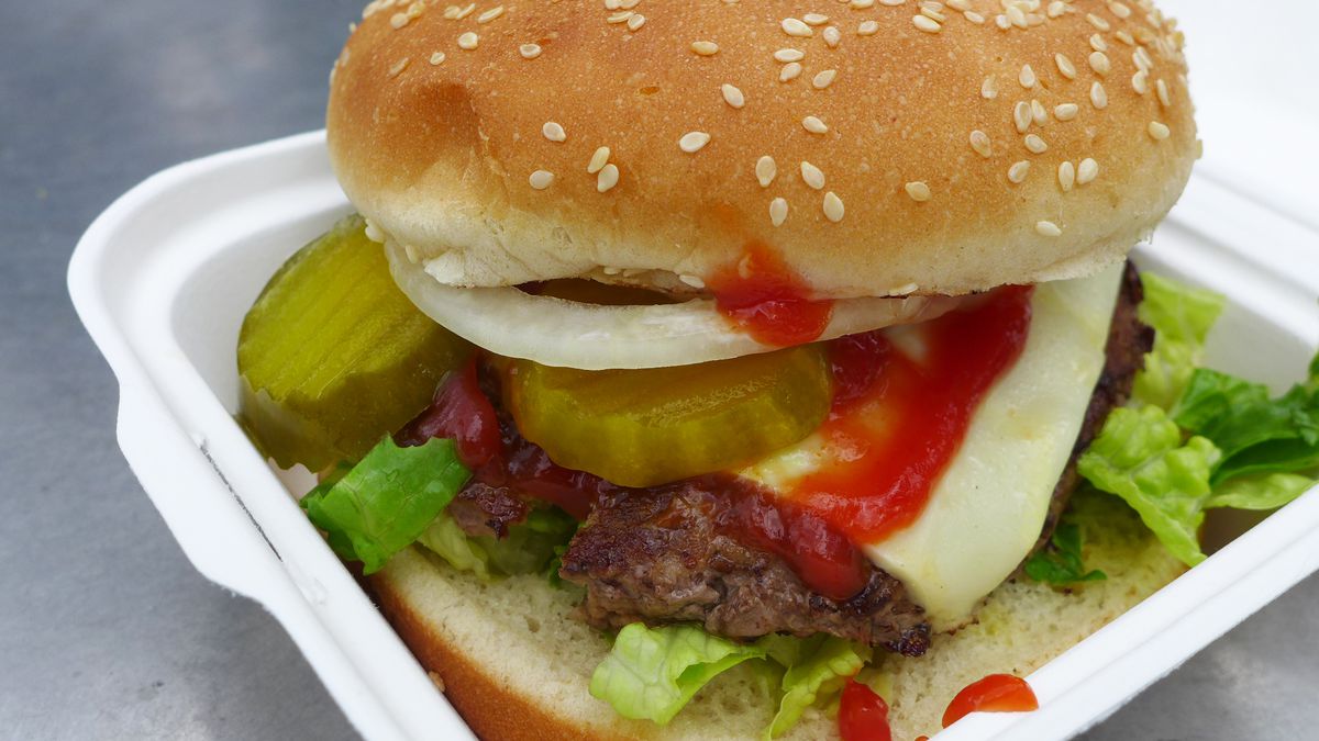 A hamburger with pickles, onions, ketchup, etc.