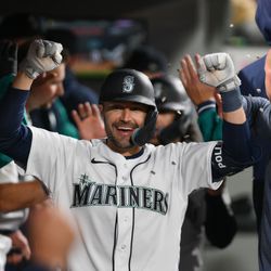 Seattle Mariners left fielder AJ Pollock (8) celebrates in the dugout after hitting a 2-run home run against the Los Angeles Angels during the fifth inning at T-Mobile Park.