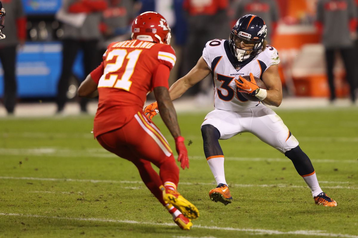 Phillip Lindsay #30 of the Denver Broncos rushes ahead of defender Bashaud Breeland #21 of the Kansas City Chiefs during the second quarter of a game at Arrowhead Stadium on December 06, 2020 in Kansas City, Missouri.