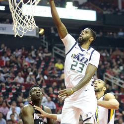Utah Jazz forward Royce O'Neale (23) shoots over Houston Rockets center Clint Capela (15) and Utah Jazz center Rudy Gobert (27) during Utah Game 5 of the NBA playoffs at the Toyota Center in Houston on Tuesday, May 8, 2018.