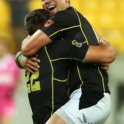 Matt Proctor of Wellington congratulates teammate Ambrose Curtis during a rugby match in New Zealand.