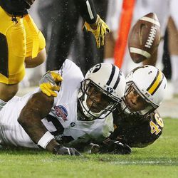 Brigham Young Cougars running back Jamaal Williams (21) fumbles after a long carry against the Wyoming Cowboys during the Poinsettia Bowl in San Diego on Wednesday, Dec. 21, 2016.