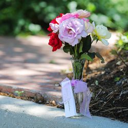 A vase of flowers were placed on the curb near the Openshaw home as friends and neighbors react Friday, June 12, 2015, in Provo to news that Mark and Amy Openshaw, both 43, long with their children, 15-year-old Tanner and 12-year-old Ellie, were killed in a plane crash on take off from their family property in western Texas County, Missouri. A third child, Max, 5, was hospitalized in critical condition.