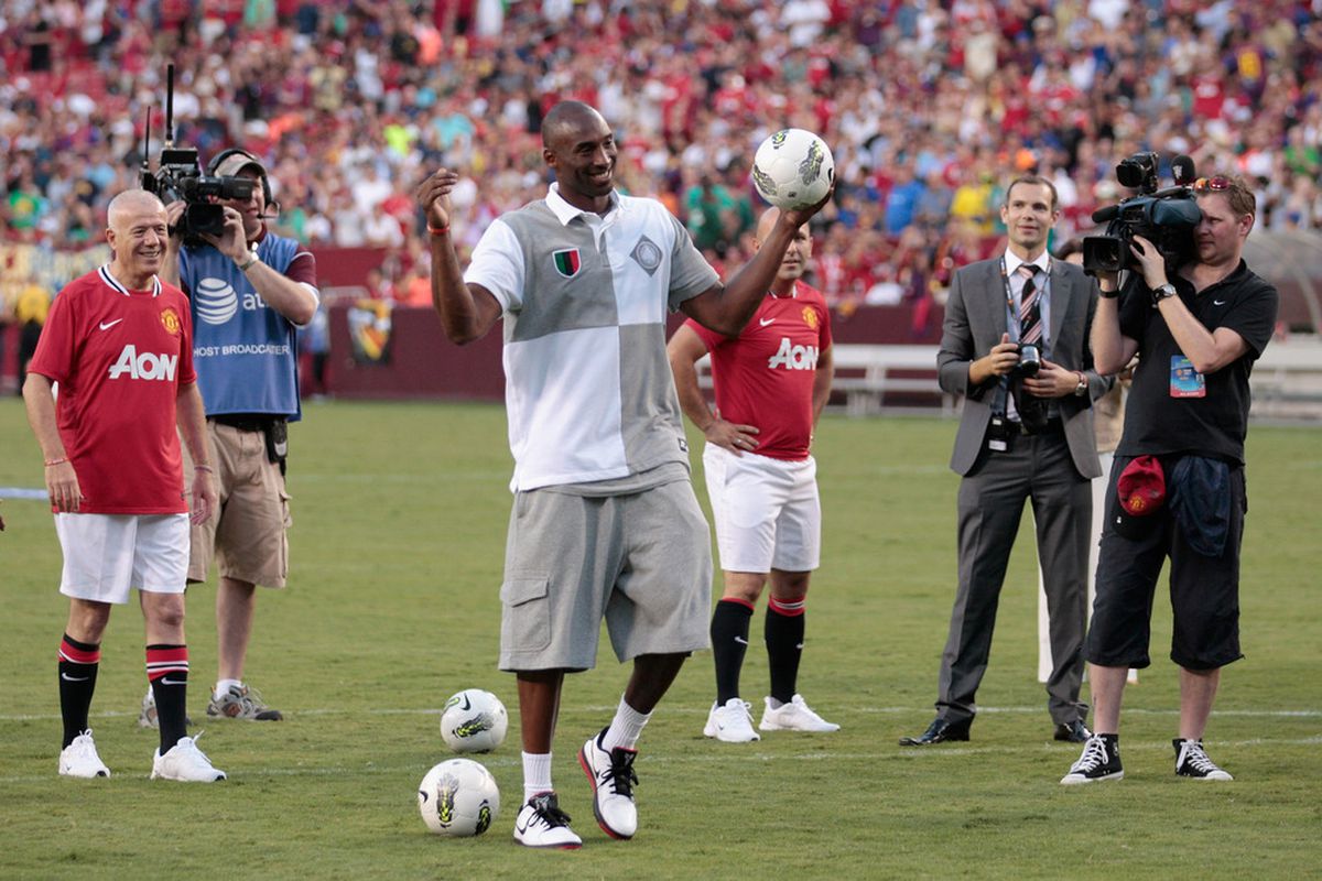 LANDOVER, MD - JULY 30:  NBA basketball player Kobe Bryant reacts to the crowd during a half time event at the Manchester United and Barcelona friendly match at FedExField on July 30, 2011 in Landover, Maryland.  (Photo by Rob Carr/Getty Images)