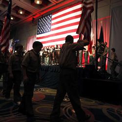 The color guard post American flags at a Boy Scouts of America banquet.