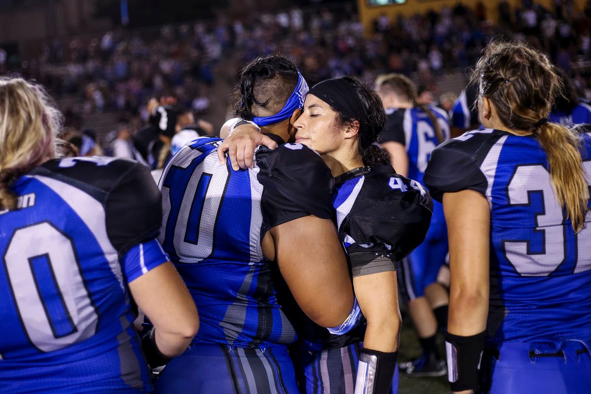 Utah Falconz offensive lineman Quinn Wesley and fullback Maira Alcala hug after winning over the the Austin Yellow Jackets in the Independent Women's Football League Championship at Cottonwood High School in Murray on Saturday, July 22, 2017.