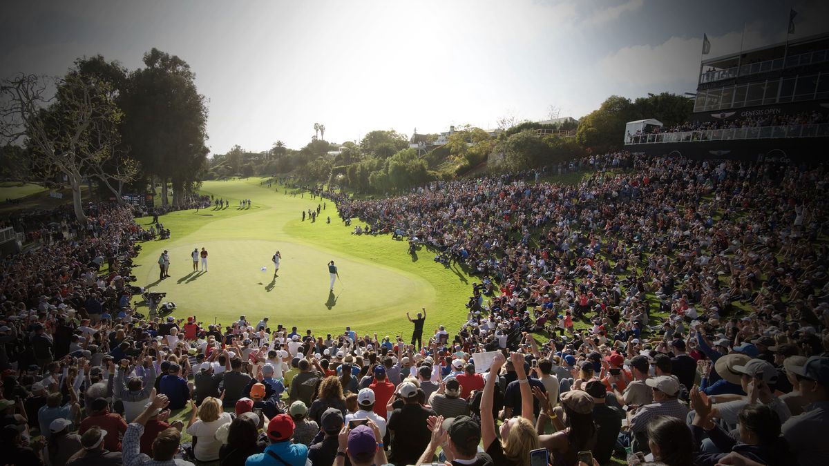 The green at The Riviera Country Club in Southern California, with crowds of spectators watching golfers. The Rivera Country Club is the host of The Genesis Invitational.