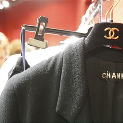 A visitor checks  Chanel outfits exhibited at a Paris auction house, Thursday.