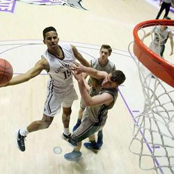 Lone Peak's Frank Jackson flips up a shot with Copper Hills' Porter Hawkins defending as they play Monday, Feb. 23, 2015, in the first round of the 5A boys basketball tournament at Weber State in Ogden.