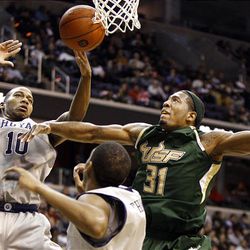 Georgetown center Greg Monroe (10) goes for a rebound against South Florida forward Jarrid Famous in the first half. Georgetown forward Hollis Thompson is in the foreground.