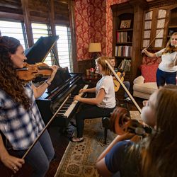 Jenny Oaks Baker, left, and her children, Hannah, Matthew, Sarah and Laura, rehearse at their North Salt Lake home on Monday, Aug. 19, 2019. They are preparing to perform for President Russell M. Nelson’s 95th birthday celebration.