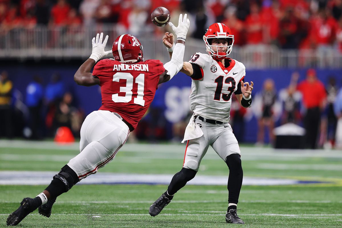 Will Anderson Jr. of the Alabama Crimson Tide pressures Stetson Bennett of the Georgia Bulldogs into throwing an interception during the third quarter of the SEC Championship game against the at Mercedes-Benz Stadium on December 04, 2021 in Atlanta, Georgia.