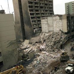 In this Aug. 8, 1998 file photo, the United States Embassy, left, and other damaged buildings in downtown Nairobi, Kenya, are shown on the day after it was bombed by terrorists. For the past three weeks, Khaled al-Fawwaz, a man portrayed by prosecutors as a key player in al-Qaida when it was in its infancy, has been on trial in New York for his part in the 1998 bombings of two American embassies in Africa.