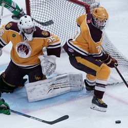 Loyola’s Timothy Hackett (7) tries to contain the puck, Friday 03-22-19. Worsom Robinson/For the Sun-Times