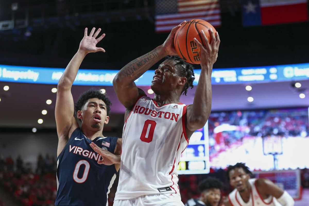 Houston Cougars guard Marcus Sasser controls the ball as Virginia Cavaliers guard Kihei Clark defends during the second half at Fertitta Center.