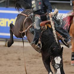 Rusty Wright, Milford, wins the saddle bronc competition during the Days of '47 Rodeo in Salt Lake City on Thursday, July 20, 2017.