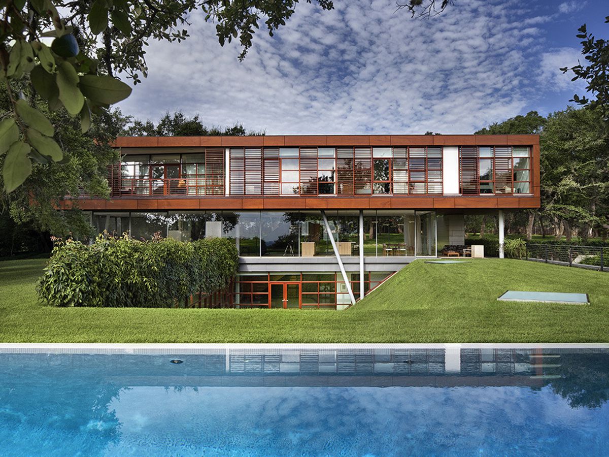 A three-story contemporary home that looks like three glass boxes stacked in descending size
