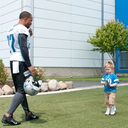 Jul 26, 2013; Allen Park, MI, USA; Detroit Lions safety Glover Quin (27) talks to a young fan before training camp at the Detroit Lions training facility. 