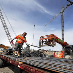 Workers unload rebar from a truck at the construction site of the new Hale Centre Theatre in Sandy on Thursday, March 3, 2016. 